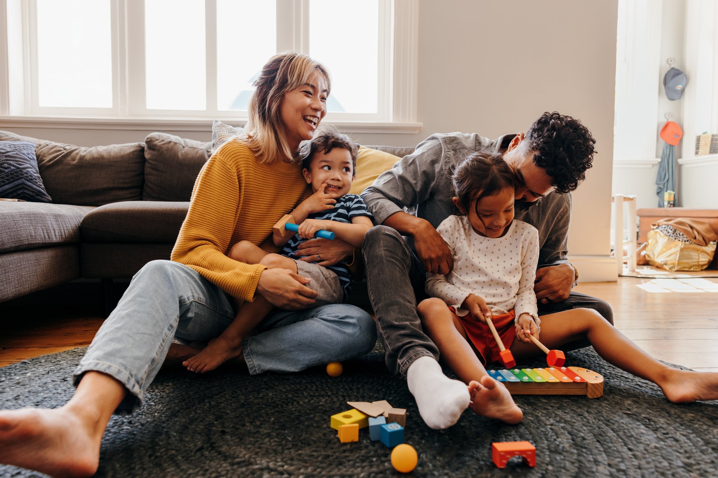 Multi-generational family playing in living room